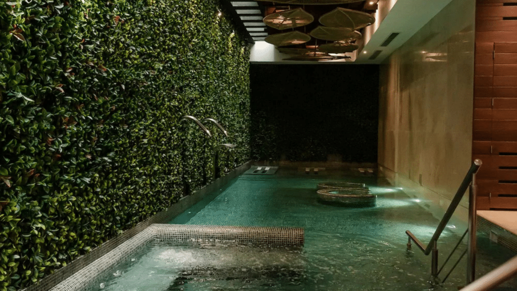 Indoor resort spa pool with a lush green living wall