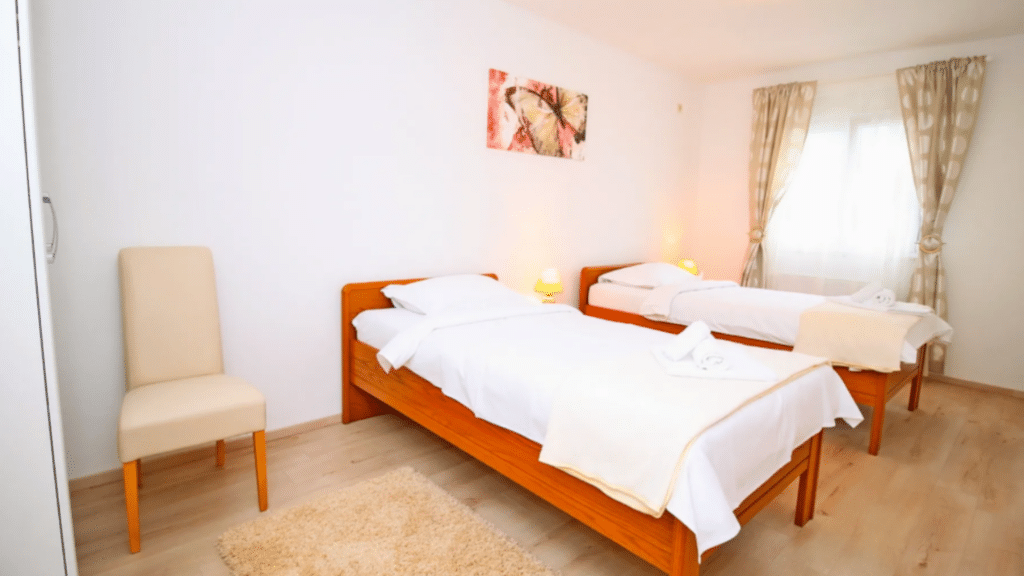 Twin bedroom with natural light inside the private Croatia villa