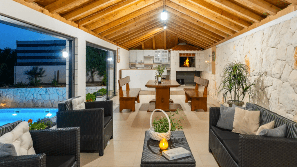 Outdoor lounge and summer kitchen beside the private villa pool